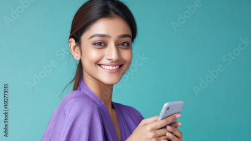 young beautiful indian woman with fair skin holding smartphone on isolated background