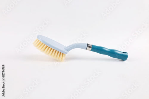 Hard bristle cleaning brush with long blue handle and ergonomic gray grip, isolated on white background