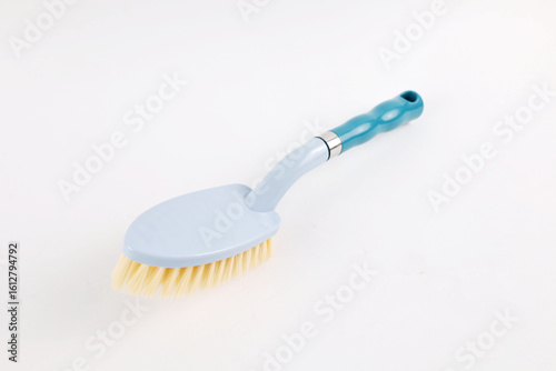 Hard bristle cleaning brush with long blue handle and ergonomic gray grip, isolated on white background
