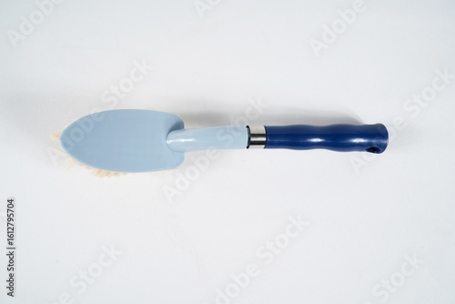 Hard bristle cleaning brush with long blue handle and ergonomic gray grip, isolated on white background