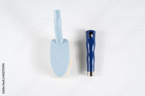 Hard bristle cleaning brush with long blue handle and ergonomic gray grip, isolated on white background