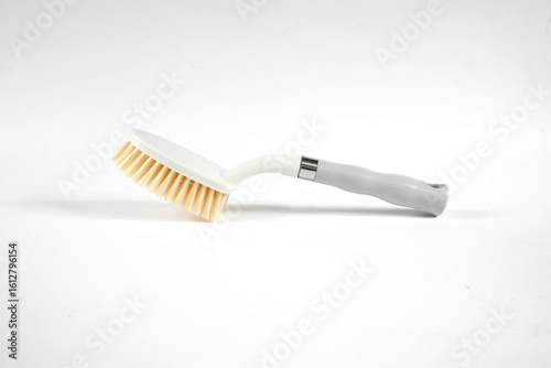 Hard bristle cleaning brush with long blue handle and ergonomic gray grip, isolated on white background