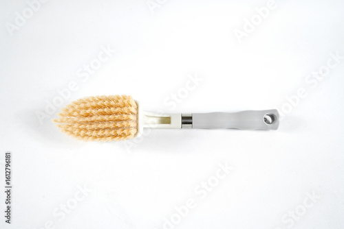 Hard bristle cleaning brush with long blue handle and ergonomic gray grip, isolated on white background