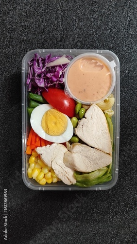 Suitable for food blogs, social media posts, and advertisements showcasing healthy eating habits and meal prep inspiration. Perfect for promoting fresh and convenient meal options.