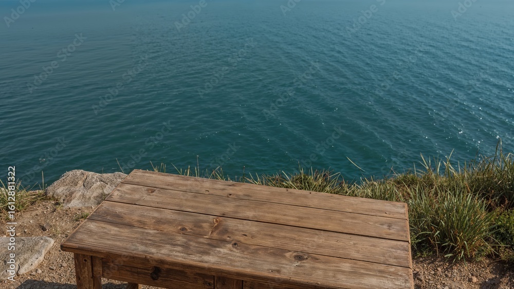 Fototapeta premium Rustic wooden table overlooking serene ocean view on a cliffside