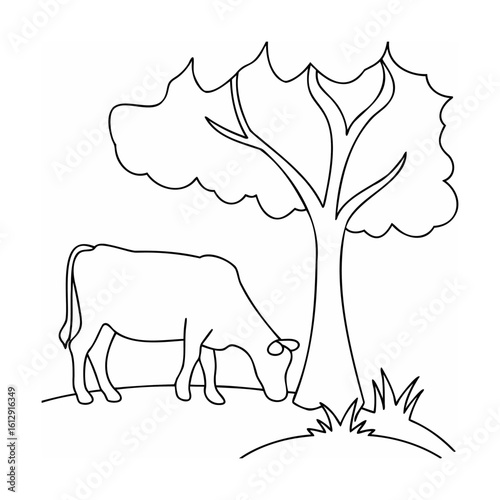 Cow grazing near a tree nature field