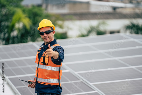 Man on roof gives thumbs up after installing solar panels in urban setting during sunny daytime