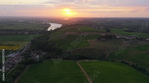 France, Gironde, Haut-Langoiran, Aerial view at sunset of the vineyard and wooded areas of Chateau de Langoiran in the Bordeaux vineyards at sunrise