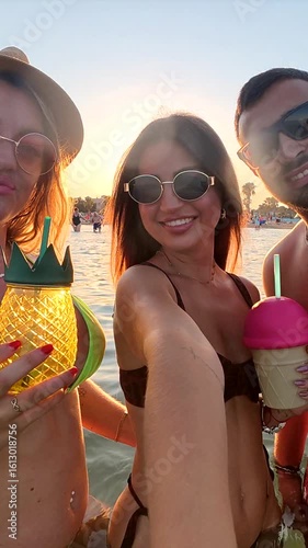 Friends enjoying sunset cocktails at the beach