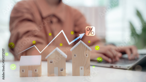 Photos Rising housing market concept with wooden house models and increasing graph, symbolizing mortgage interest rates, real estate investment growth, and property price trends