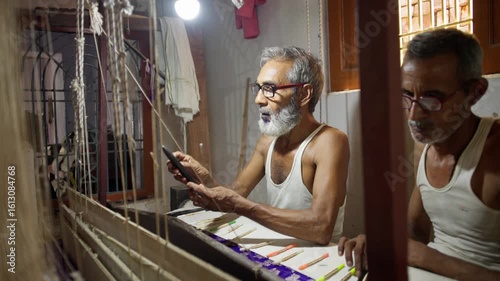 Two skilled men weaving intricate silk fabric on a traditional handloom in a small village workshop in Varanasi, India, showcasing fine Indian textile craftsmanship.