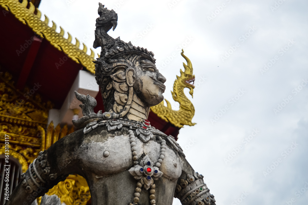 Fototapeta premium Old Thai Angel Statue, Symbols of Buddhism, Southeast Asia at Wat Chang Kam or Wat Kan Thom, Wiang Kum Kam Chiang Mai, Northern Thailand