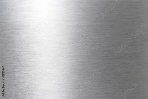 Brushed metal texture with bright light reflections and subtle lines