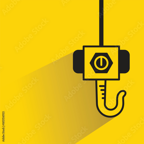 industrial hoist and crane hook with shadow yellow background
