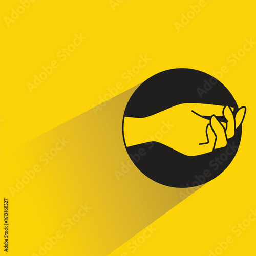 begging hand gesture with shadow on yellow background