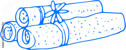 A set of rolled towels accompanied by a flower