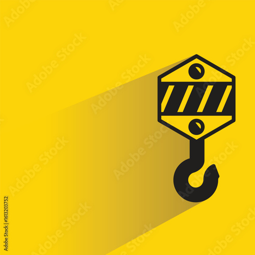 pulley crane hook icon with drop shadow on yellow background