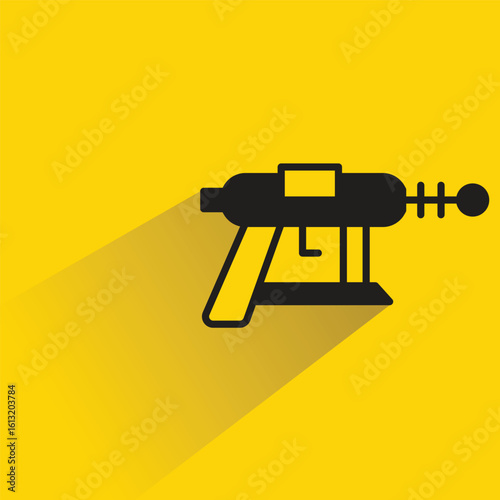 space gun with shadow on yellow background