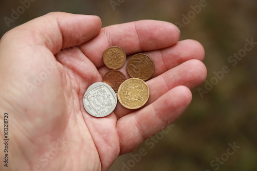 Coins of South Africa in hand