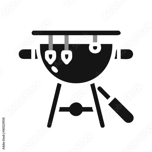 Black barbecue grill with grilling tools on a white background 
