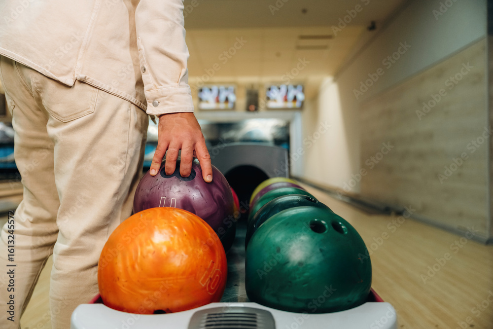 Fototapeta premium Taking the ball. Close up view of man that is playing bowling