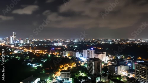 Wallpaper Mural Aerial View of Cityscape at Night with Illuminated Buildings and Street Lights under Dark Cloudy Sky in Asia Torontodigital.ca