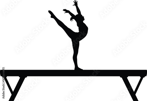 Graceful female gymnast performing a split leap on a balance beam in silhouette