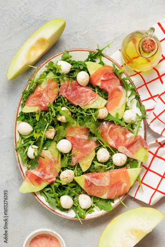 Cuadro en lienzo Melon Mozzarella Prosciutto Salad with Arugula..top veiw.