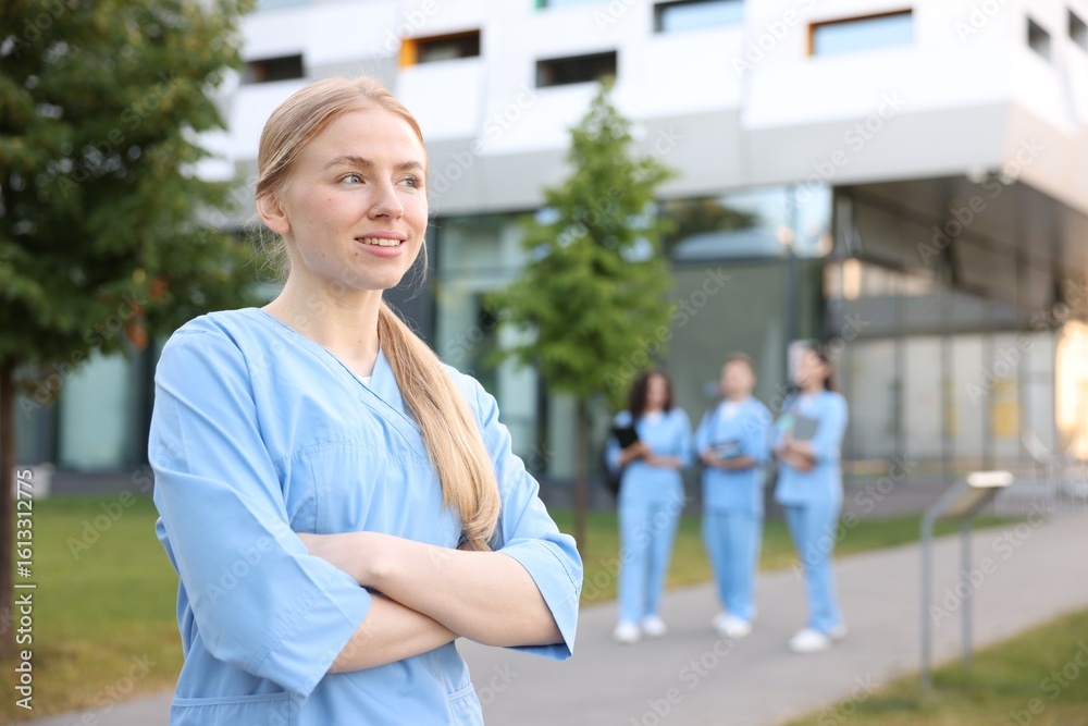 Fototapeta premium Medical student in uniform outdoors, selective focus