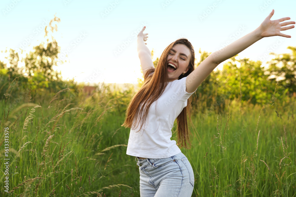 Feeling freedom. Happy young woman enjoying time in nature Feeling freedom. Happy young woman enjoying time in nature