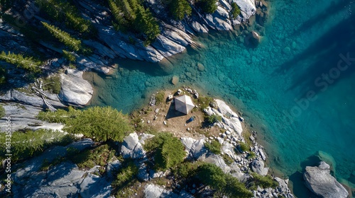 Top down view of solo camping tent beside turquoise mountain lake crystal clear water reflecting sky peak rocky terrain scattered pine tree serene remote alpine landscape detailed fabric fold shadow