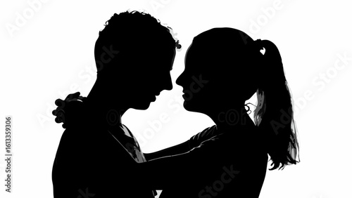 Silhouette of a young couple embracing each other in a close affectionate pose against a white backdrop