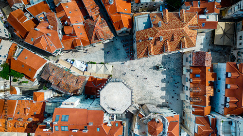 Aerial view of terracotta rooftops casting warm shadows over the ancient stone streets leading to the Peristyle courtyard, Split, Split-Dalmatia County, Croatia.