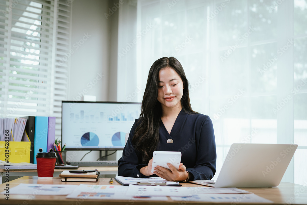 A cheerful businesswoman celebrates success while holding a smartphone at her desk, surrounded by documents, charts, and a laptop in a bright, modern office space. A cheerful businesswoman celebrates success while holding a smartphone at her desk, surrounded by documents, charts, and a laptop in a bright, modern office space.