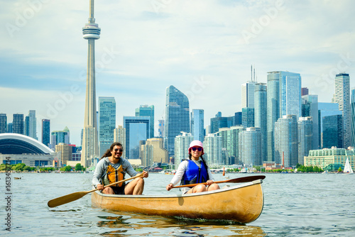 Photography Active outdoor lifestyle: young adult couple paddling a canoe on the Toronto Isl