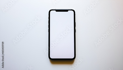 A modern black smartphone with a blank white screen is shown from above on a white surface.