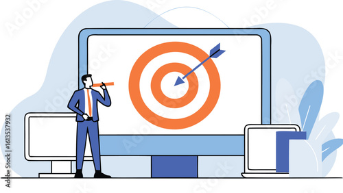 Man standing near a large computer screen with a target and arrow displayed on the screen design