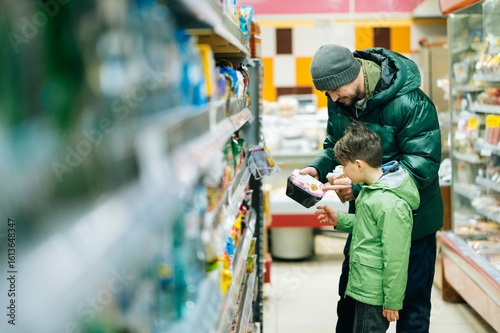 Dad and son shopping for groceries in a supermarket