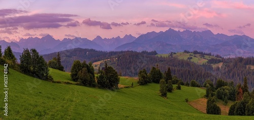 Fototapeta Naklejka Na Ścianę i Meble -  Beautiful summer sunrise in the mountains. Tatra Mountains seen from near Zakopane, Lesser Poland, Malopolska. Polish Rural Landscape With Tatry Mountain At Sunrise. Polskie gory.