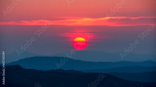 Vibrant Sunset Over Layered Blue Mountains sunrise