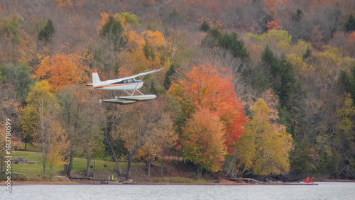 Fotografía Float plane sea plane takes off from lake in Ontario Canada with backdrop of end