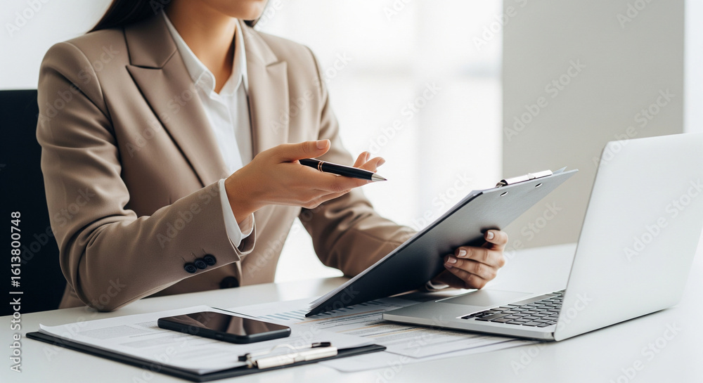 Fototapeta premium Female Professional in a Business Meeting, Working with Laptop and Documents in a Modern Office