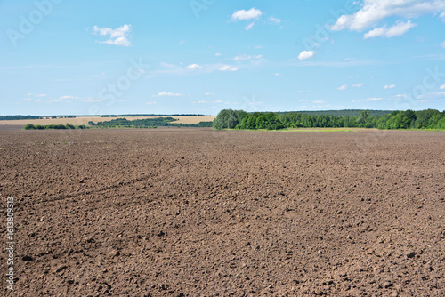 Tilled Field Under Blue Sky isolated agricultural industry