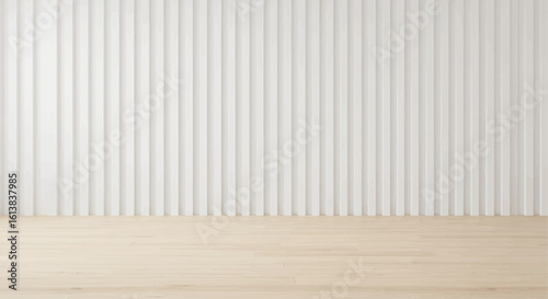 Minimalist interior design featuring a light wood floor and a textured white wall.