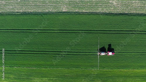 Aerial View of Tractor on Vast Green Field