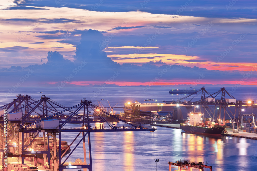 Obraz premium Background for cranes and industrial cargo ships in port at twilight.