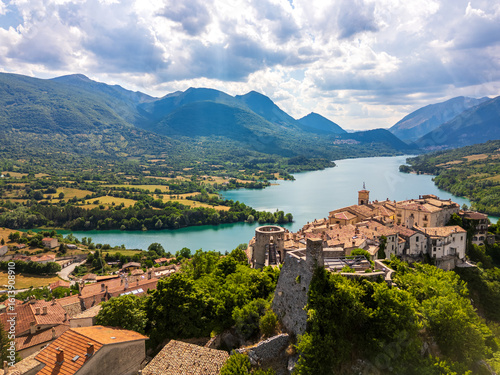 Aerial drone view of the medieval village of Barrea with its magnificent lake in the province of L'Aquila, Abruzzo. This place exudes history, peace, and tranquility.

