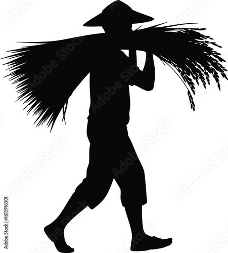 Silhouette of a farmer carrying a large bundle of hay