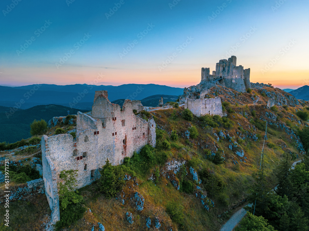 Obraz premium Italy, July 5, 2025: Ruins of Rocca Calascio Castle, an Italian tourist destination and landmark in the Gran Sasso National Park, L'Aquila, Abruzzo. Clear blue skies at sunset.