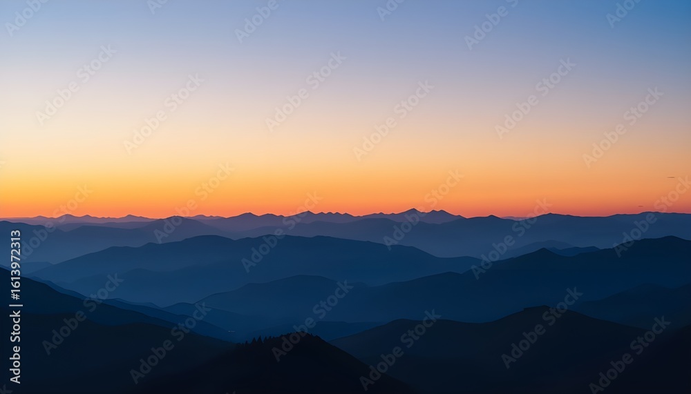 Fototapeta premium Distant Ridge Silhouette at Sunset: Layers of Blue and Purple Mountains